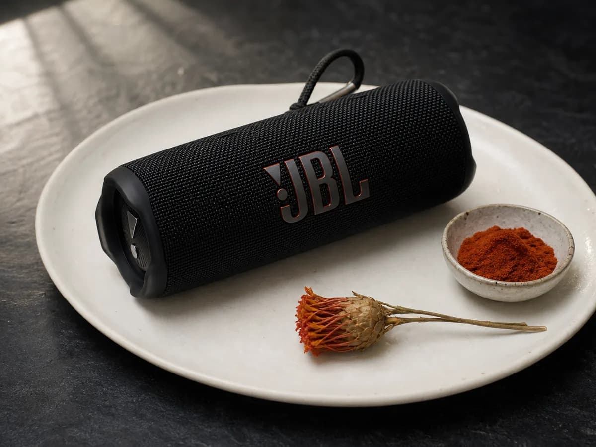 Flip 7 centered on a white ceramic plate beside a small bowl of paprika, one dried flower stem