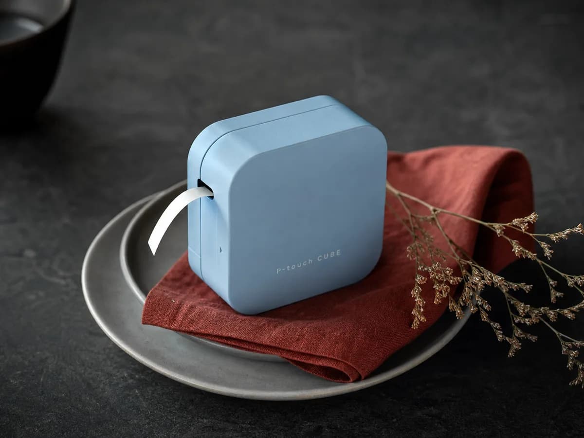 P-touch Cube plated on a matte ceramic dish with a paprika-red linen napkin and a sprig of dried flowers